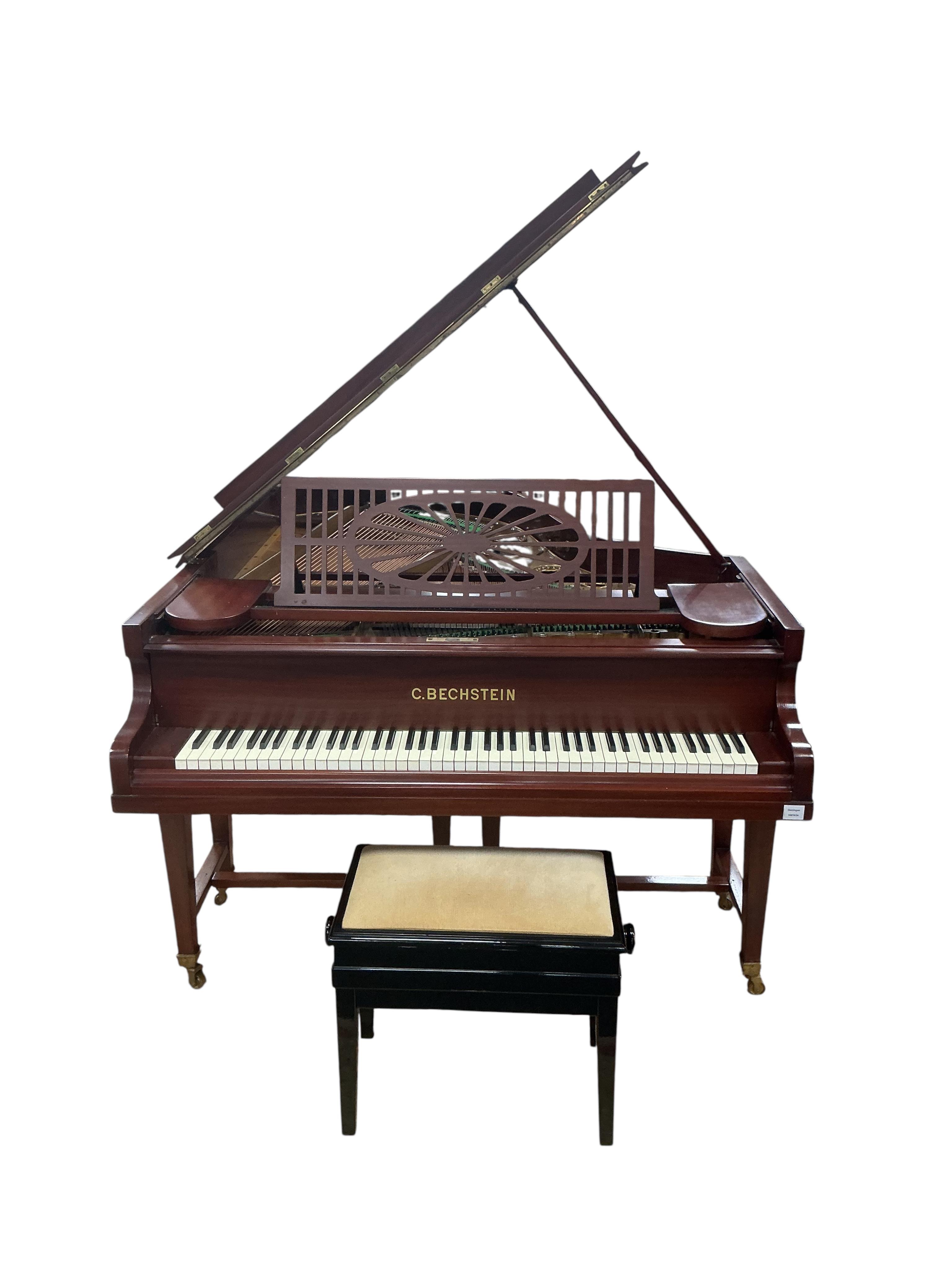 A Bechstein mahogany cased boudoir grand piano, model A, number 96003 (c.1910). Recently restrung, new felt to hammers and case re-polished, together with an adjustable ebonised piano stool. Length 182cm, depth 144cm.